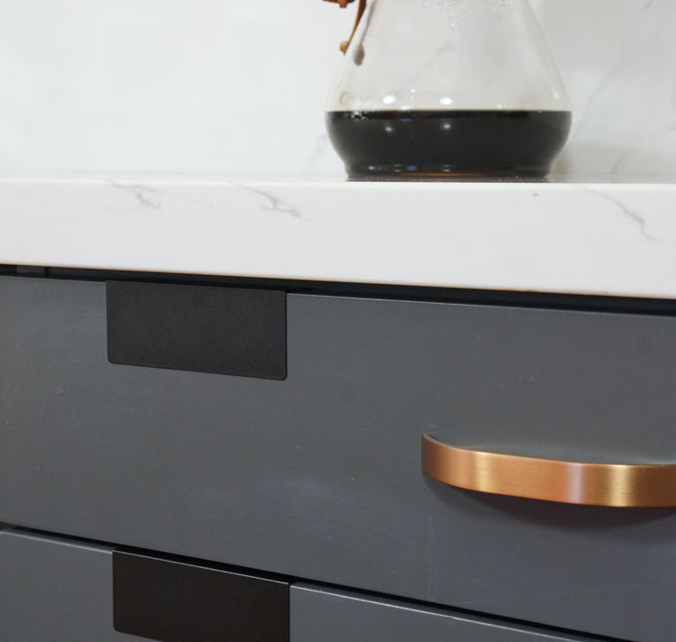 Close-up of a black clip on a gray drawer